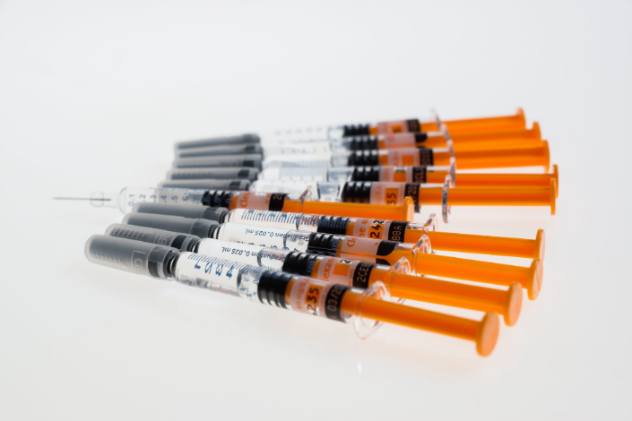 syringes on a white surface